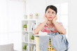© PR Image Factory - woman leaning on laundry basket feeling bored