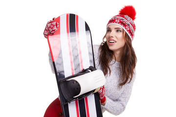 Wall Mural - Woman wearing winter suit holding a snowboard in studio