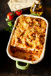 Tasty lasagne covered with cheese in baking dish