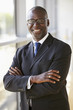 © Monkey Business - Portrait of a smiling businessman with arms crossed