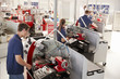 © Monkey Business - Trainee engineers operating equipment in a small factory