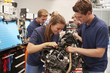© Monkey Business - Apprentice car mechanics working on an engine
