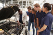 © Monkey Business - Mechanic instructing trainees around the engine of a car