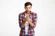 © Drobot Dean - Portrait of a happy amused man looking at mobile phone