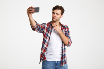 Sticker - Portrait of an attractive young man taking a selfie