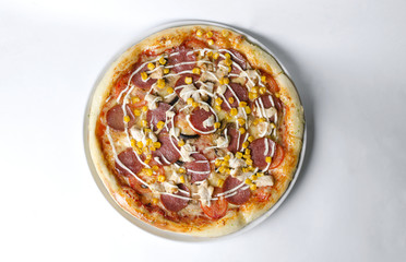 Wall Mural - Pizza with ham salami and mushrooms on a white plate