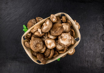 Wall Mural - Portion of Raw Shiitake mushrooms on a slate slab