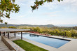 © trinettereed/Stocksy - Backyard pool at luxury modern design home