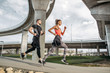 © dijanato/Stocksy - Couple running together outside.