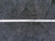 © Greg Schmigel/Stocksy - Abstract white lines painted on distressed asphalt concrete surface