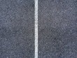 © Greg Schmigel/Stocksy - Abstract white lines painted on distressed asphalt concrete surface