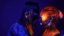 Portrait Of A Bearded Man And Woman Painted In Ultraviolet Powder