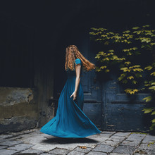 Young Woman In A Long Blue Dress Dancing