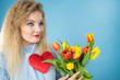 © Voyagerix - Woman holds tulips and red heart