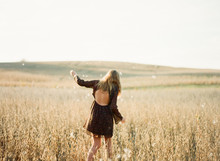 Girl Playing A Soy Field With Seed Fluff