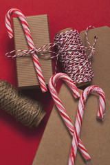 Canvas Print - Festive Christmas present with candy cane on a red background