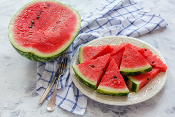 Wall Mural - Half of watermelon and a dish of sliced watermelon.