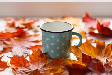 Wall Mural - autumn. fallen leaves and a rustic mug of warm tea