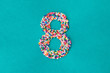 © Kathryn Swayze/Stocksy - The number eight built from nonpareils