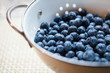 © Carolyn Lagattuta/Stocksy - Close up of a colander full of freshly washed blueberries