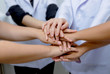 © praisaeng - Doctors and nurses in a medical team stacking hands,Medical team cooperation