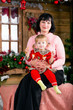 Portrait of lovely mother and her cute daughter sitting next to christmas tree. waiting for Santa.