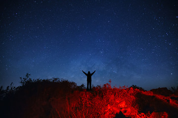 Wall Mural - landscape with milky way galaxy, starry night sky with stars and silhouette of a standing sporty man