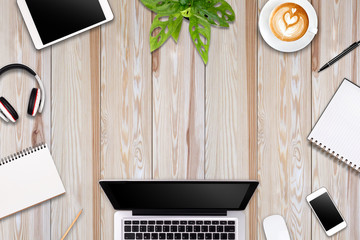 Modern workspace with laptop tablet, smartphone and coffee cup copy space on color background. Top view. Flat lay style.