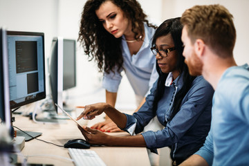 Software engineers working on project and programming in company