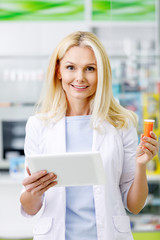 Wall Mural - pharmacist with digital tablet and medication