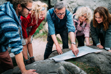 Group Of Hikers Checking Route On Map