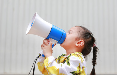 Asian little girl announce by megaphone. Communication concept.