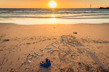 Wall Mural - Australia text with thongs, flag and sunglasses on beach