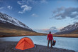© tolstnev - Hiker stand at camping in the mountains during springtime.