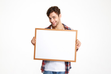 Sticker - Portrait of a happy young guy holding blank board