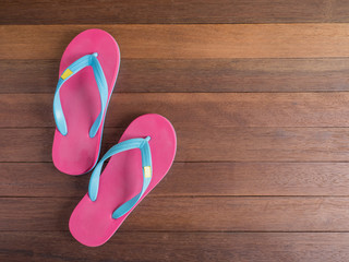 Pink flip flop on wooden floor 2