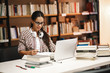 © BalanceFormCreative - Young female student study in the school library.She using laptop and learning online.