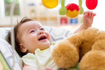 Wall Mural - Baby boy playing with his toy in his house