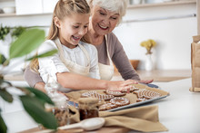 Joyful Old Woman Giving Sweet Pastry To Kid