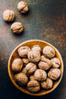 © Anikonaann - Whole walnuts on dark stone concrete table background. Copy space. Healhty Vegetarian Vegan Food Concept