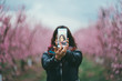 © JavierPardina/Stocksy - woman taking photos to the pink trees