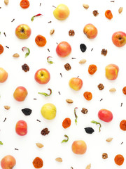 Wall Mural - Pattern of red apples, prunes and dried dried apricots. The concept of a healthy diet. Composition of fruits on a white background. Top view, flat lay.