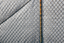 Chainlink Fence In Front Of Silver Tarp