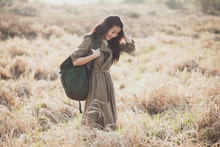 Asian Girl With A Backpack In The Wilted Fields