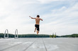 © Cara Slifka/Stocksy - Boy jumps off dock into a lake