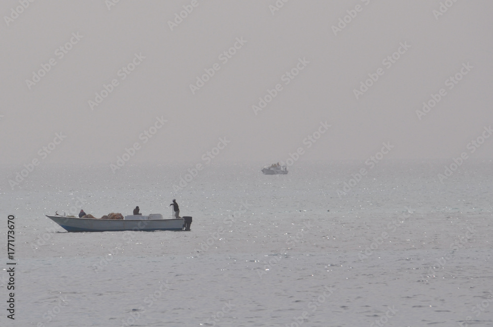 Egyptian fishermen on a fishing boat in the middle of the red sea in ...