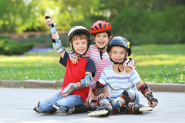 Cheerful children on roller skates in park