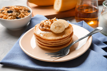 Wall Mural - Plate with yummy banana pancakes on table