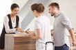 © Africa Studio - Young couple near reception desk in hotel