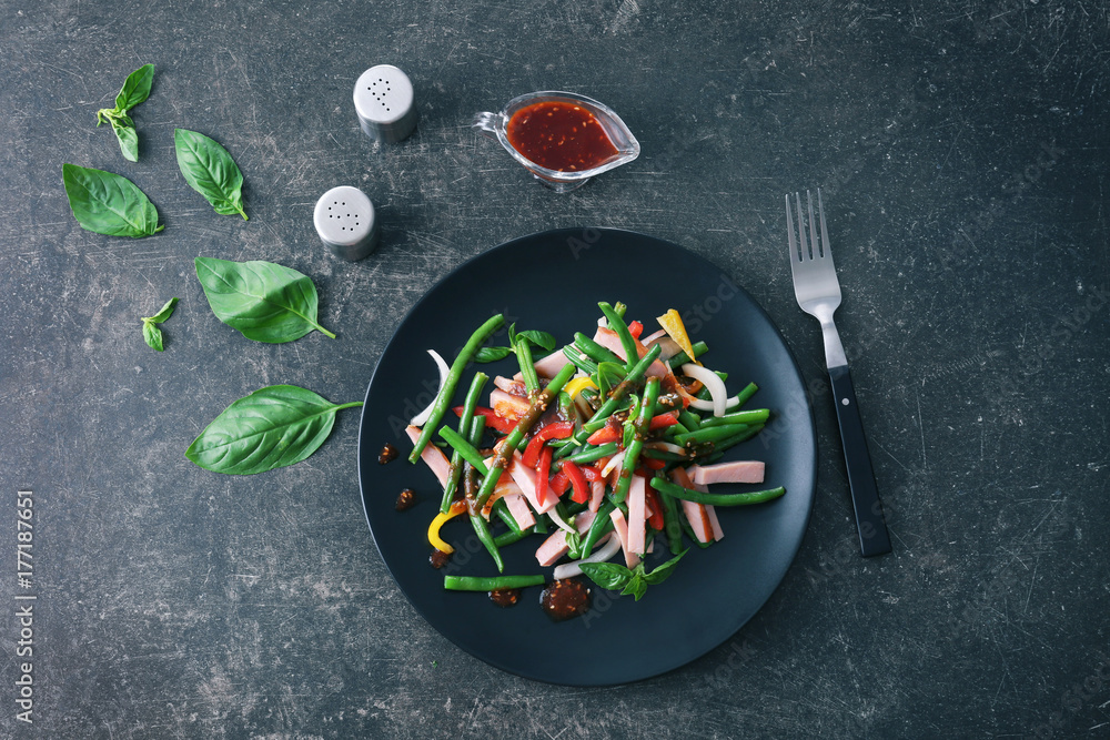 Plate with delicious green beans salad on kitchen table